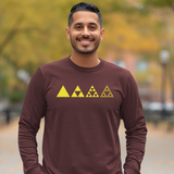A smiling man wearing a long-sleeve maroon shirt with a yellow fractal triangle graphic across the chest, set against a blurred outdoor background of autumn trees.